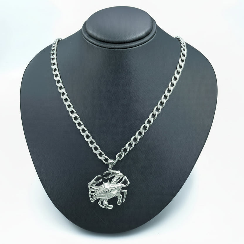 Silver crab necklace on a black bust with a white background