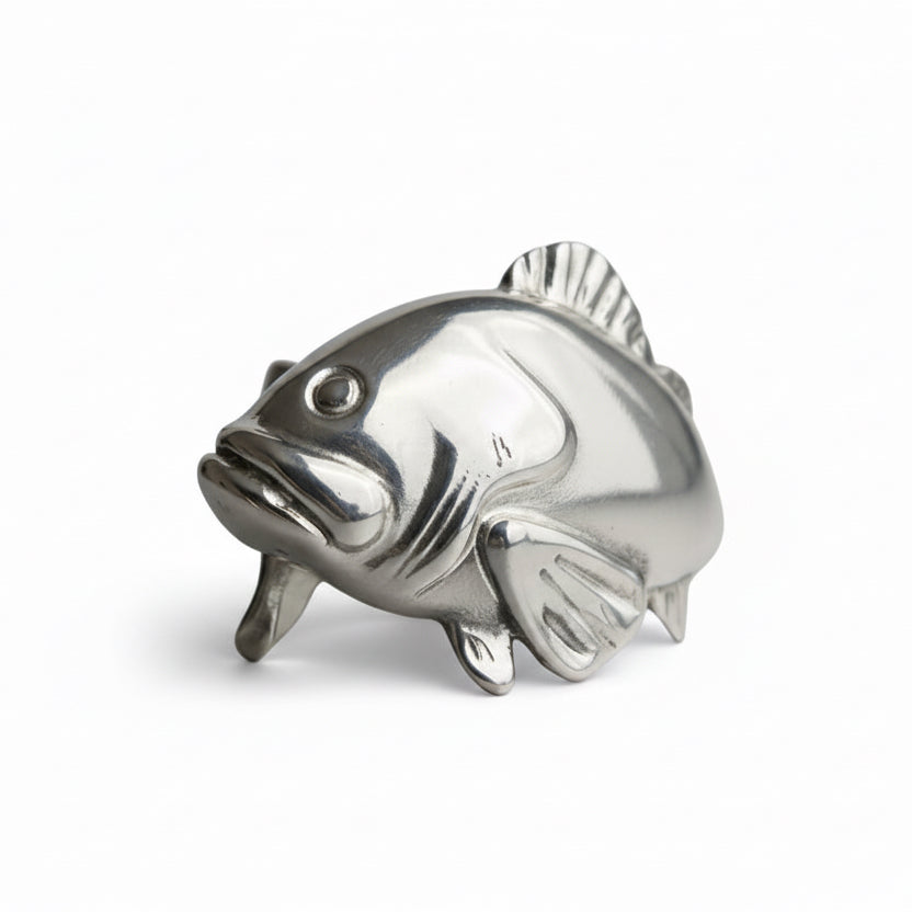 Silver fish-shaped object on a gray background