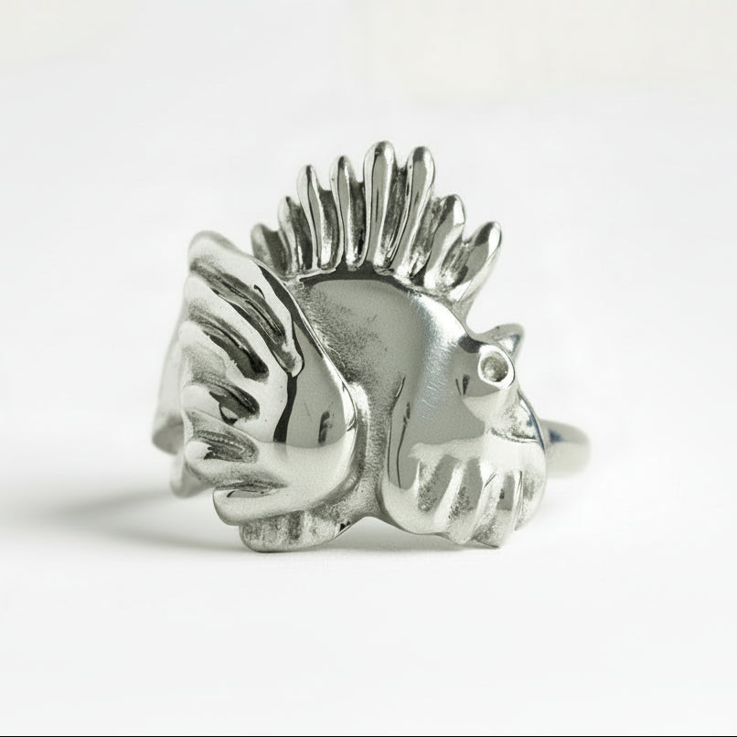 Silver lionfish-shaped ring on a white background