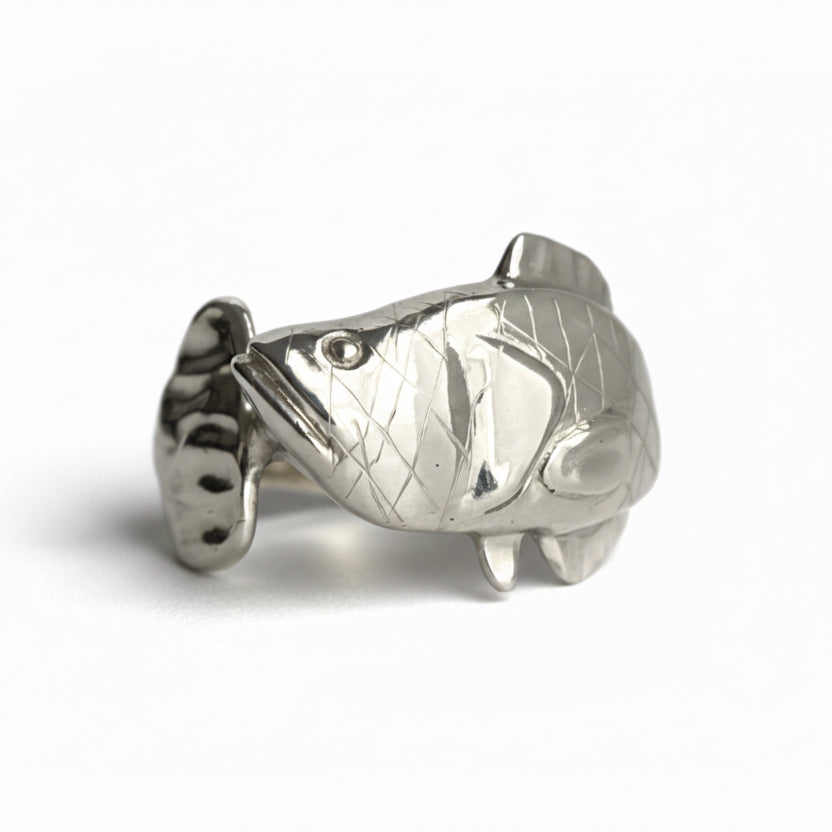 Silver Snakehead fish-shaped object on a light gray background