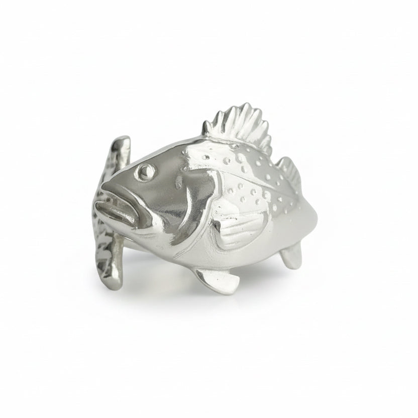 Silver fish-shaped object on a light gray background