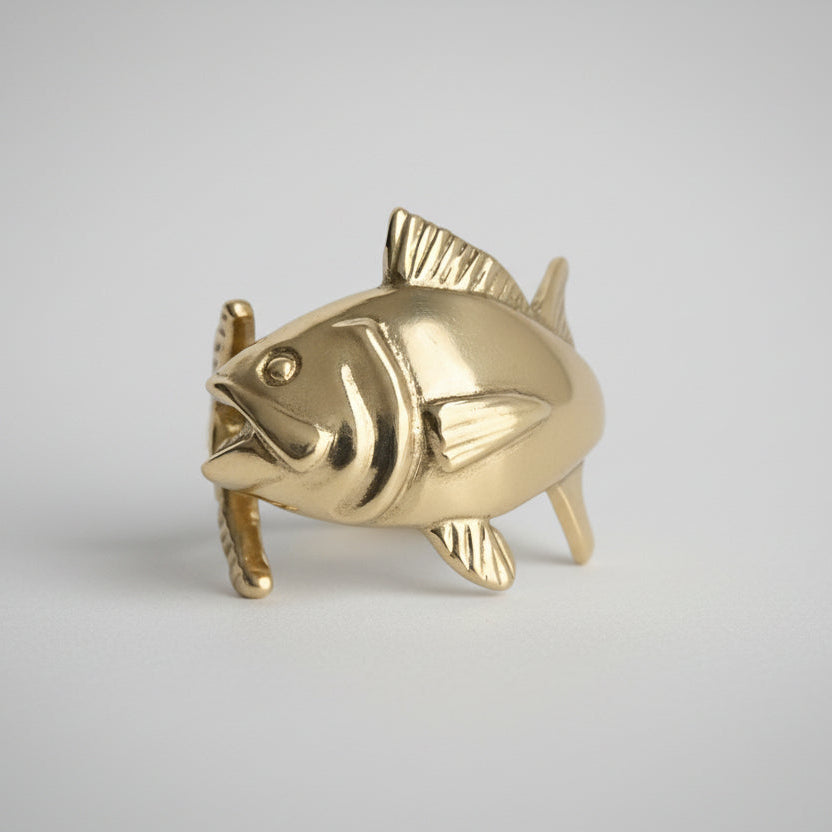 Gold tuna fish ring on a white background