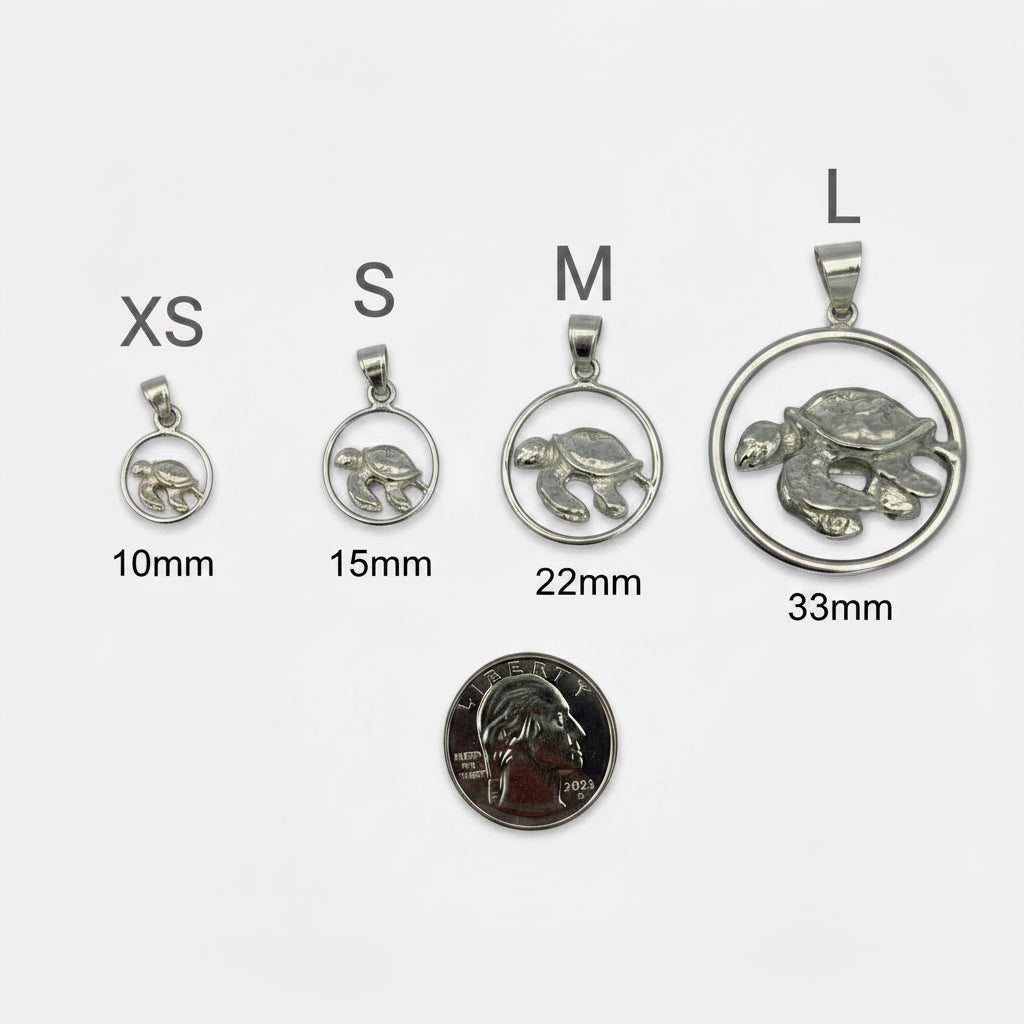 Three silver turtle pendants of different sizes on a white background with a quarter for scale.