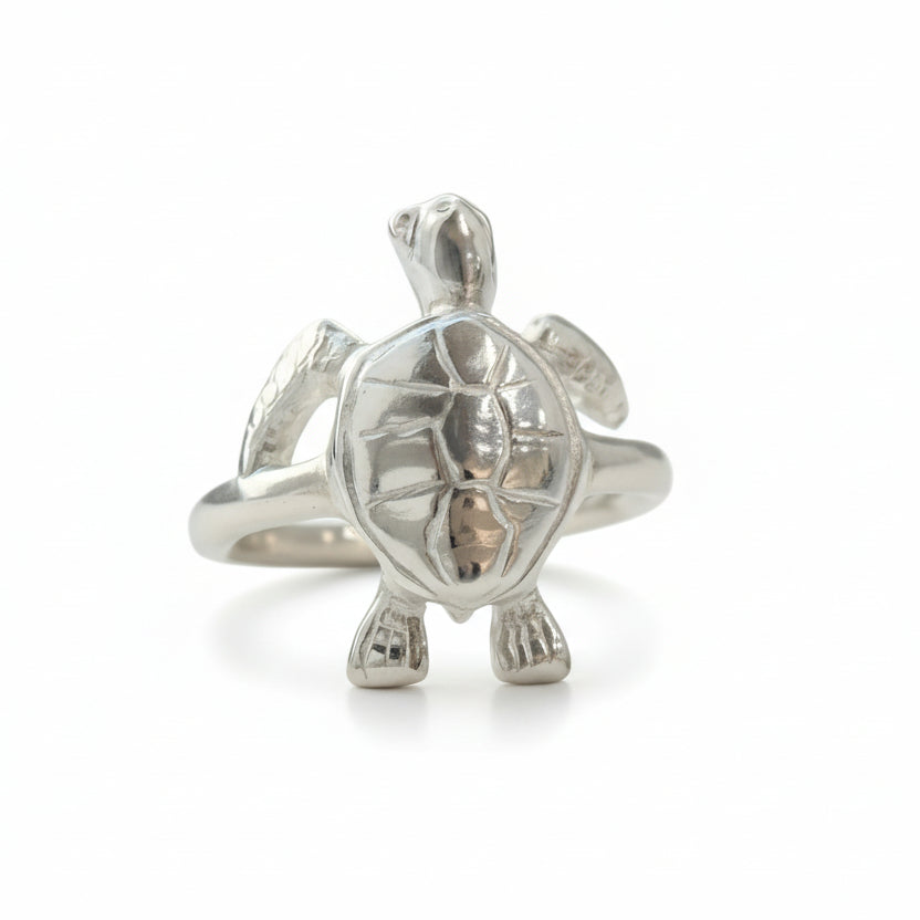 Silver turtle-shaped ring on a light gray background