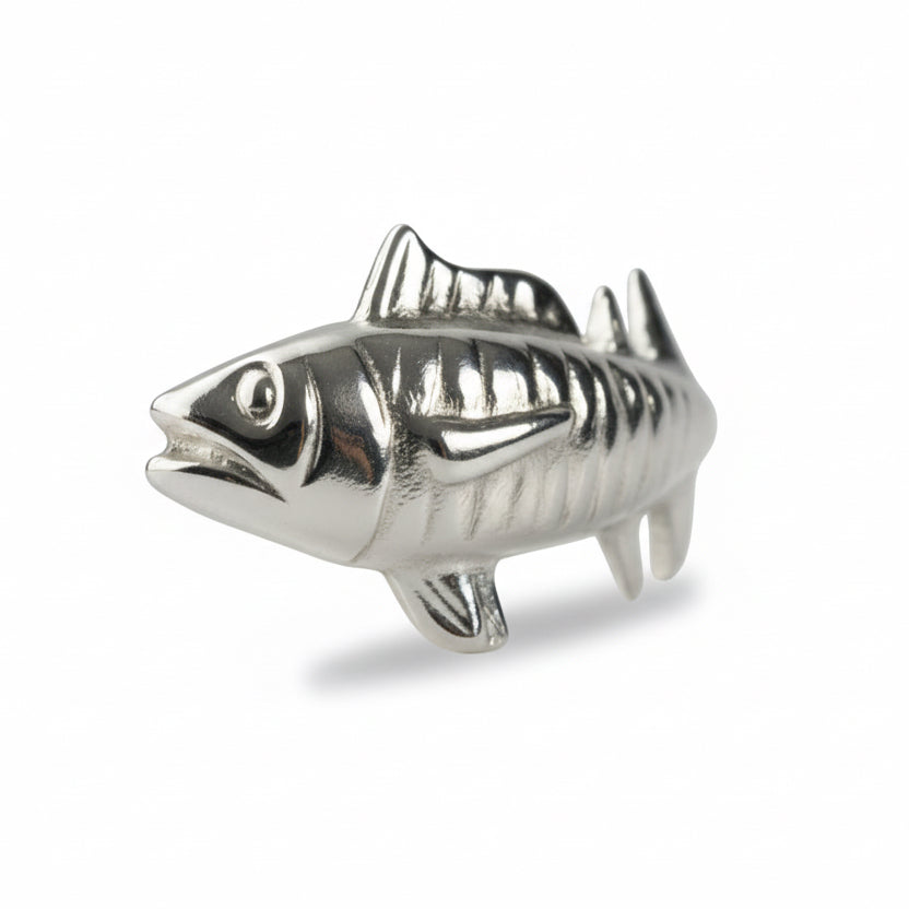 Silver fish-shaped object on a white background