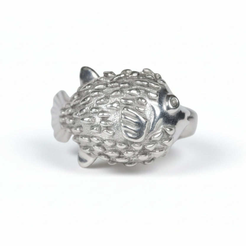 Silver puffer fish figurine on a white background