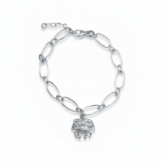 Silver chain bracelet with a crab charm on a light gray background