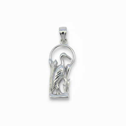 Silver pendant with blue heron design on a light gray background