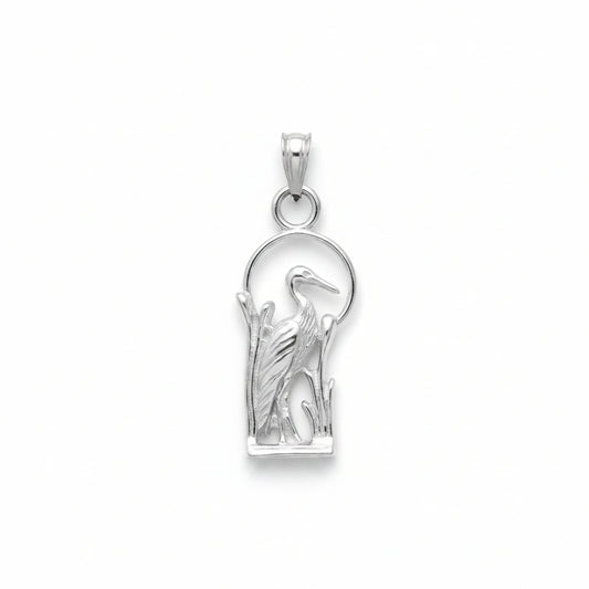 A sterling silver pendant featuring a detailed heron standing among reeds, set against a minimalist circular background, shown on a plain white background.