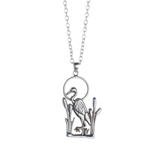 Silver blue heron leg up necklace on a gray background