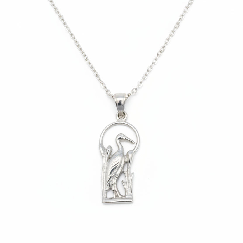 Silver blue heron pendant with a design on a white background