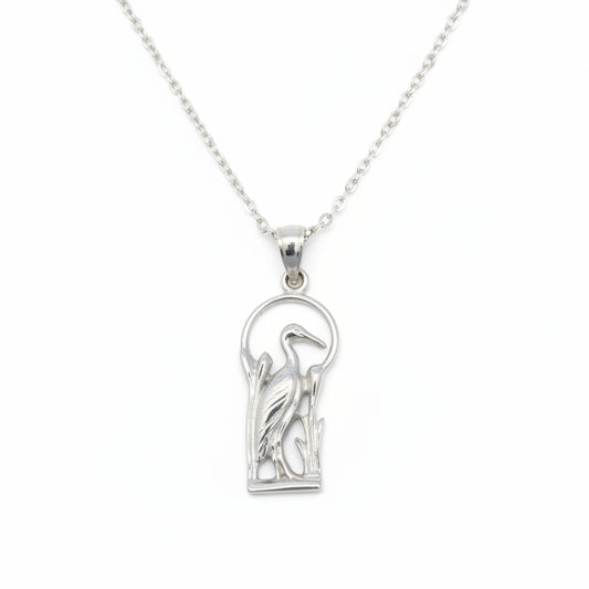 Silver blue heron pendant with a design on a white background