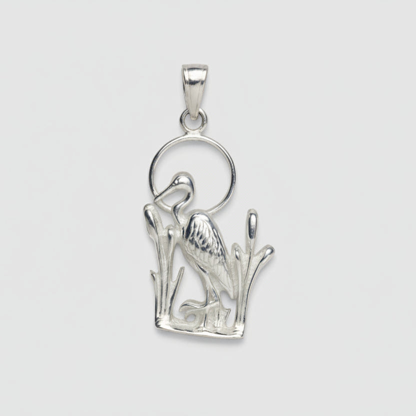 Silver blue heron charm on a white background