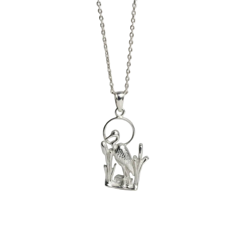 Silver blue heron necklace  on a light gray background
