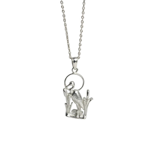 Silver blue heron necklace  on a light gray background