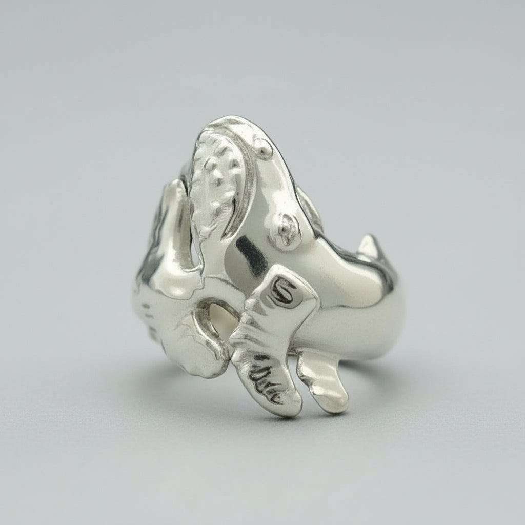 Silver breaching whale ring  on a white background