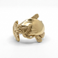 Gold catfish-shaped ring on a white background