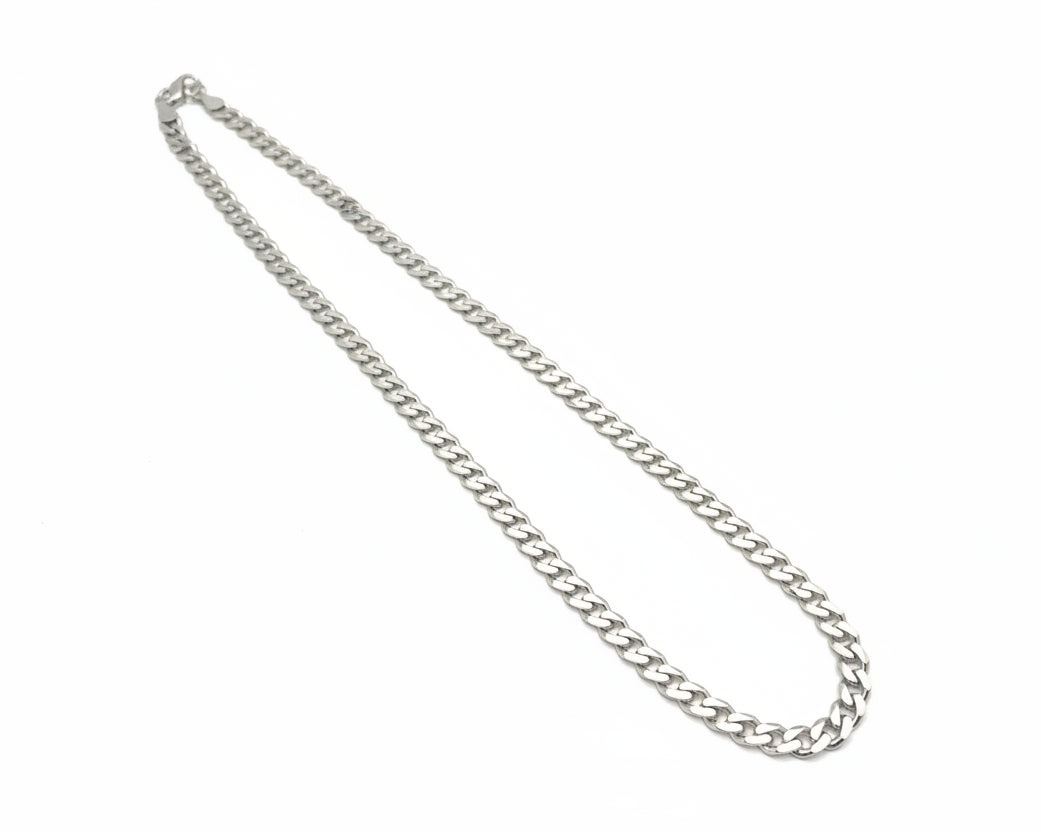 Silver chain necklace on a light gray background