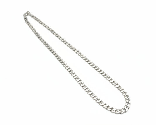 Silver chain necklace on a light gray background