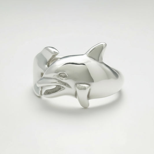 Silver dolphin-shaped ring on a light gray background