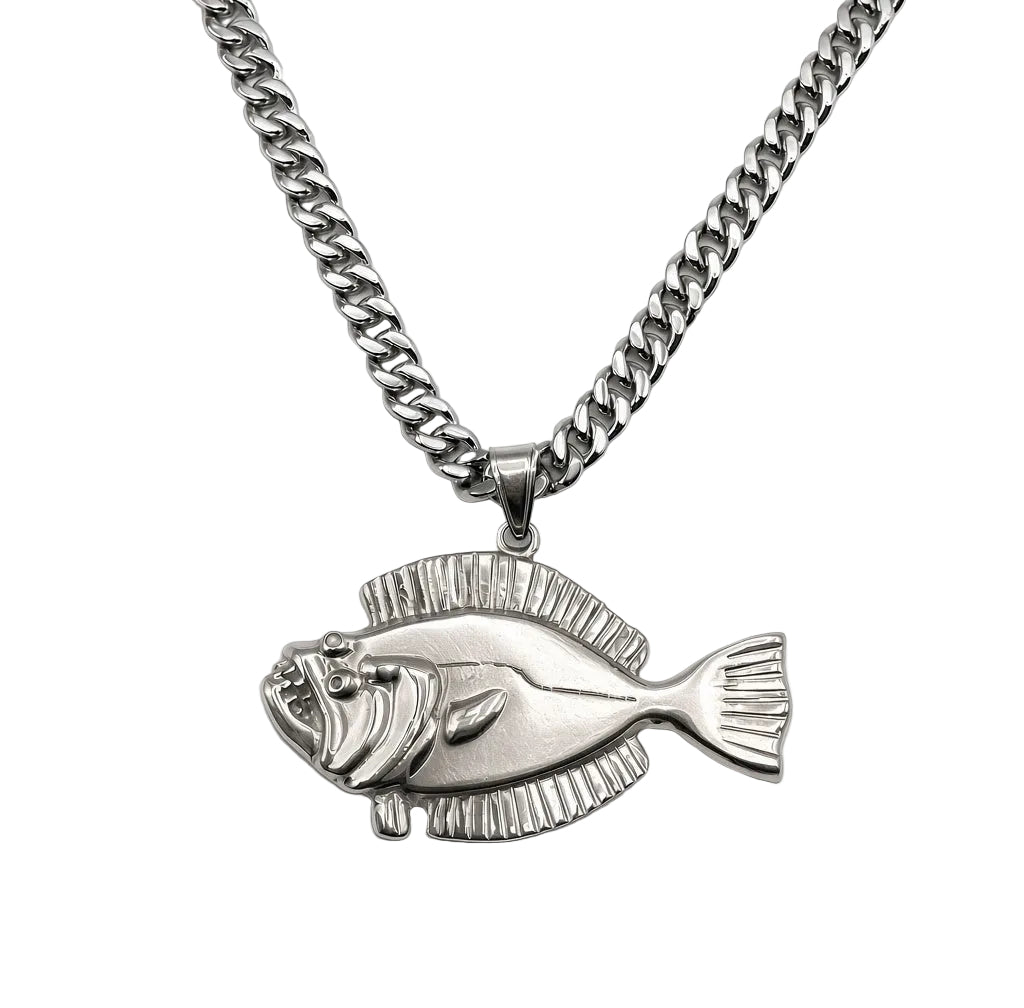 A silver-toned metal necklace featuring a detailed fish-shaped pendant, displayed on a clean white background.