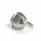 Silver ring with a unique design on a light gray background