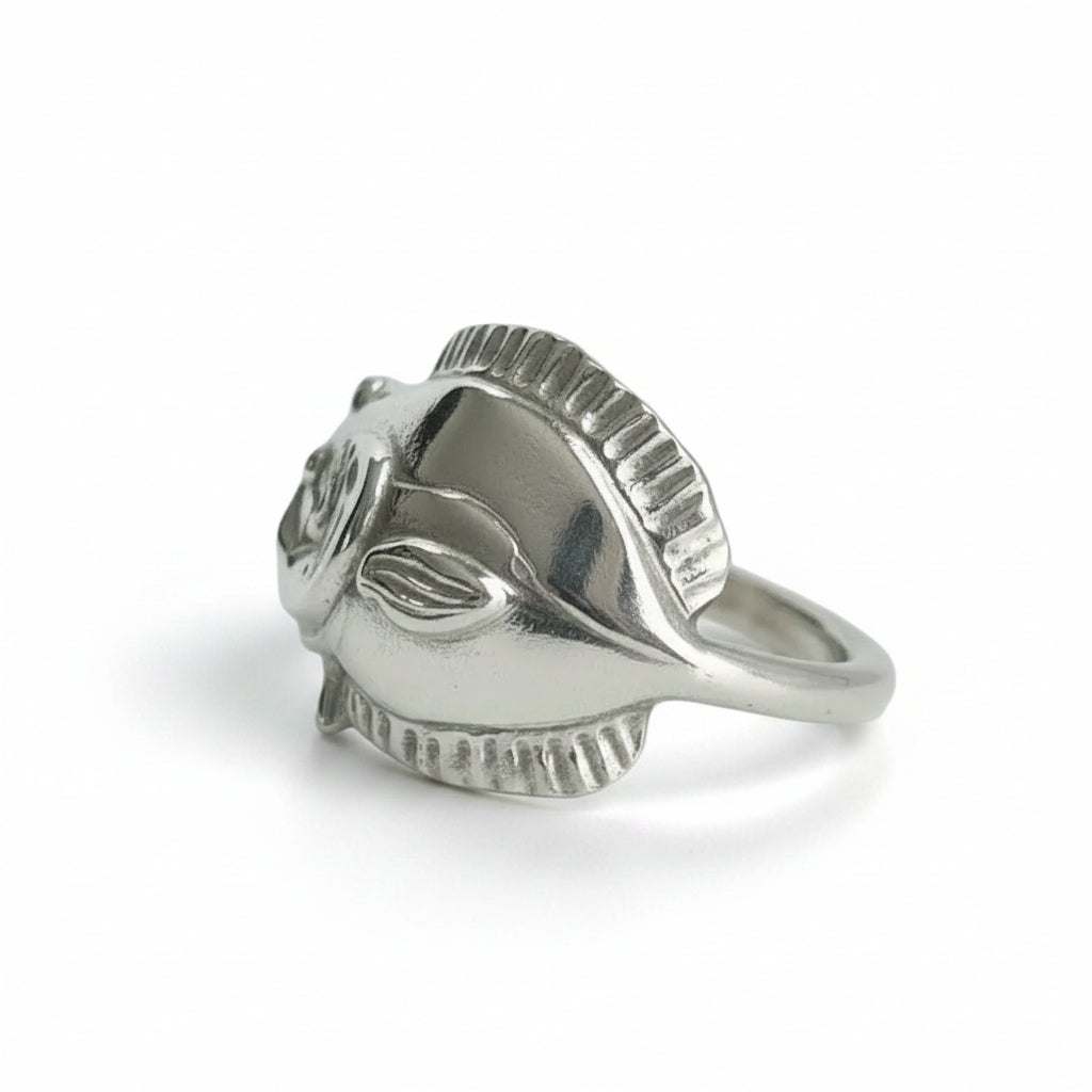 Silver ring with a unique design on a light gray background