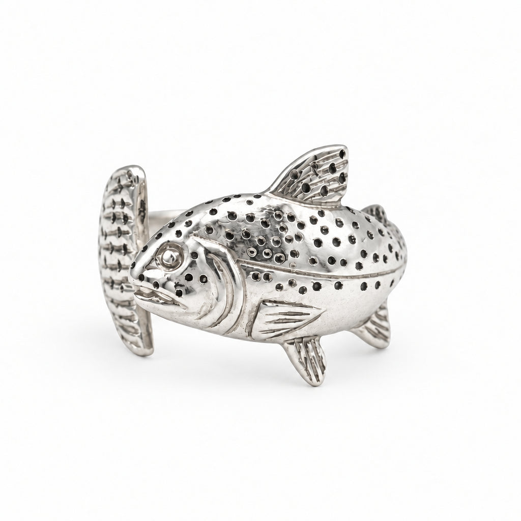 A silver fish-shaped ring with detailed textured spots and fins, displayed on a white background.
