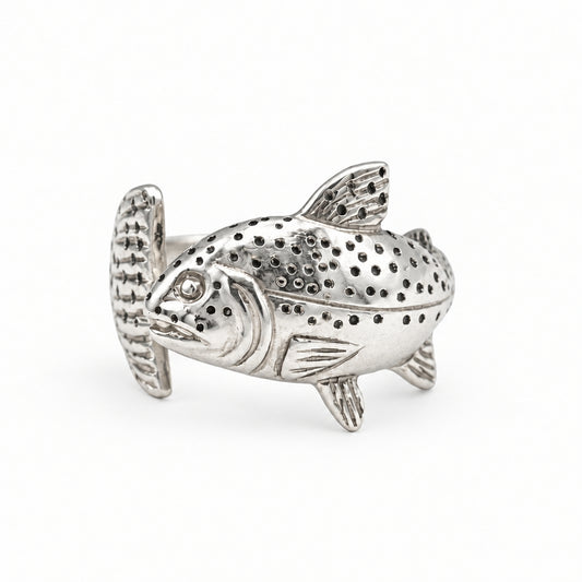 A silver fish-shaped ring with detailed textured spots and fins, displayed on a white background.
