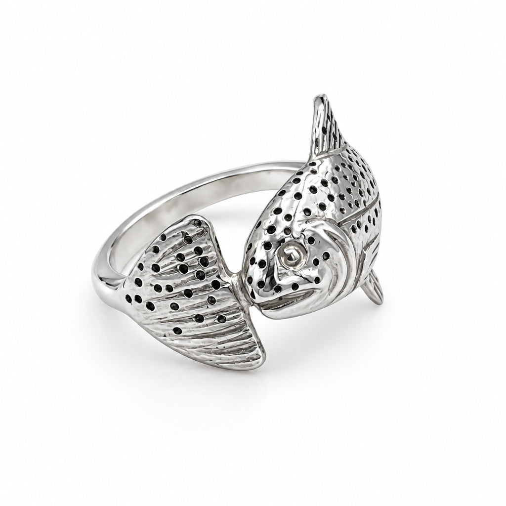 A sterling silver ring shaped like a jumping fish, featuring textured scales and small black oxidized dots, set against a white background.