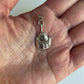 Horseshoe Crab Charm on Hand in white background