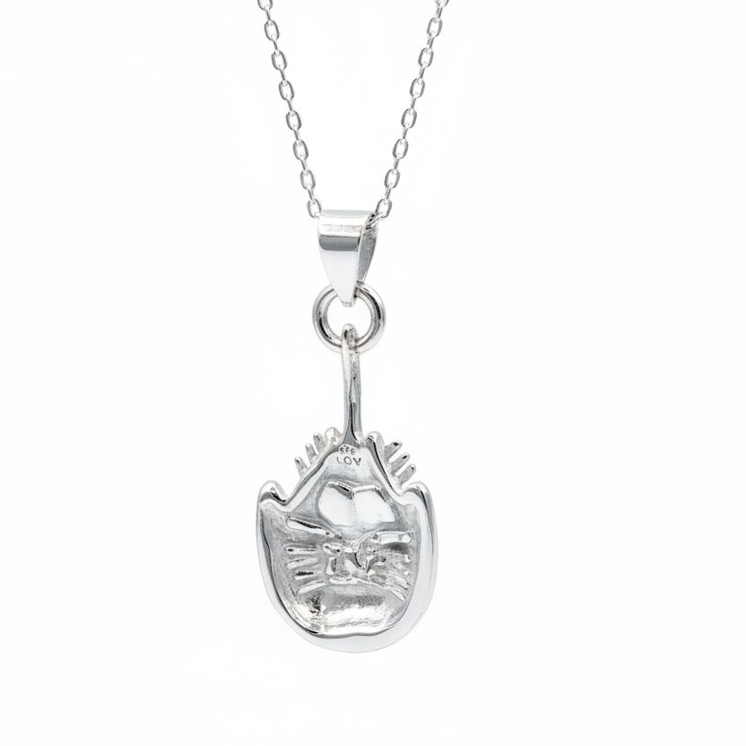 Silver horseshoe crab pendant necklace on a plain background