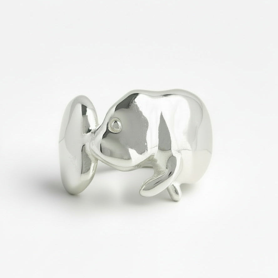 Silver manatee-shaped ring on a white background