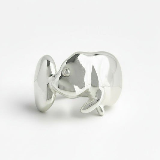 Silver manatee-shaped ring on a white background