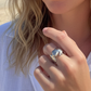 Woman on a beach with a ring on her finger