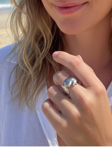 Woman on a beach with a ring on her finger