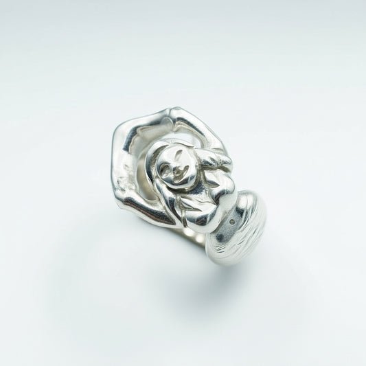 Silver ring with a mermaid design on a light gray background, mermaid is hold on her tale