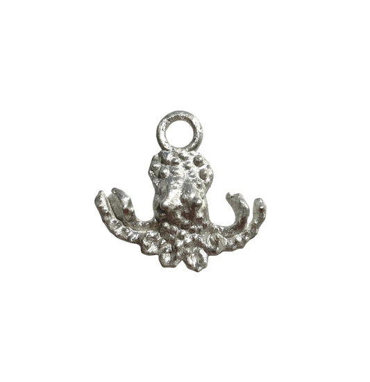 Silver octopus charm on a light gray background