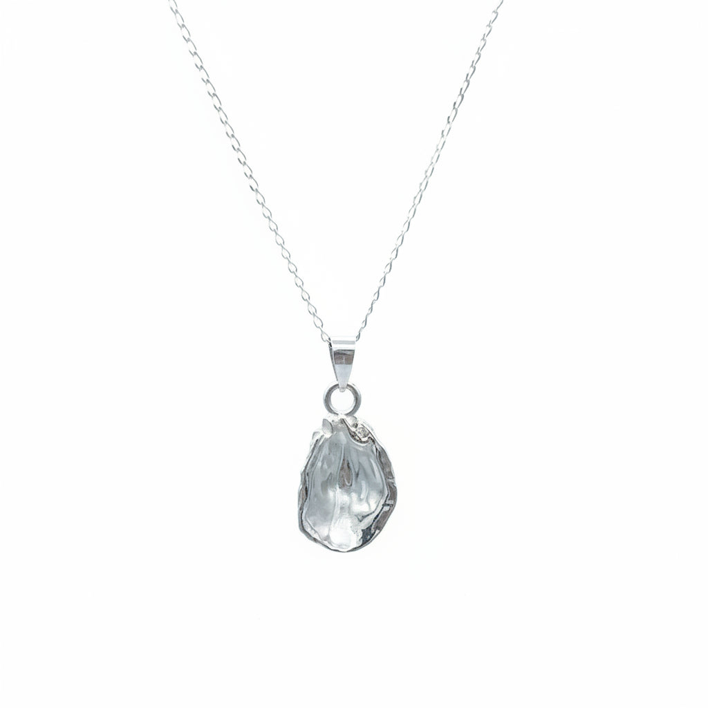 Silver necklace with a oyster-shaped pendant on a light gray background