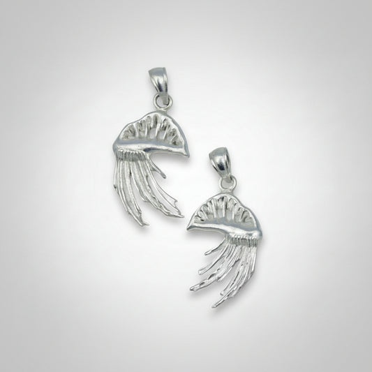 Two Portuguese Man O War-shaped pendants on a gray background