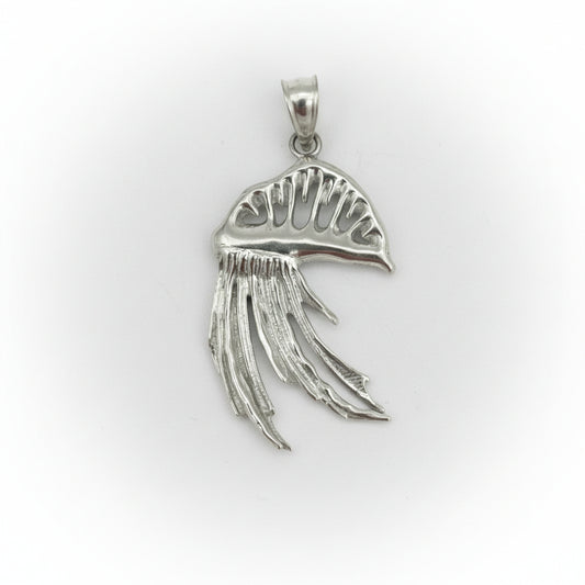 Silver pendant with Man o' war design on a gray background