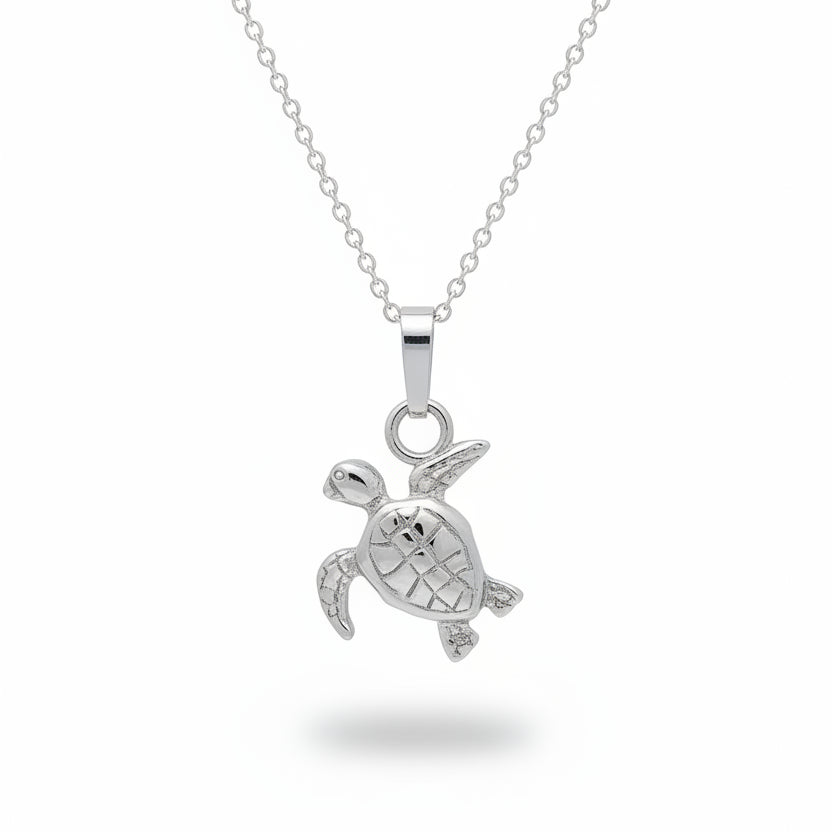 A silver sea turtle pendant necklace on a matching silver chain, displayed against a textured light gray background.