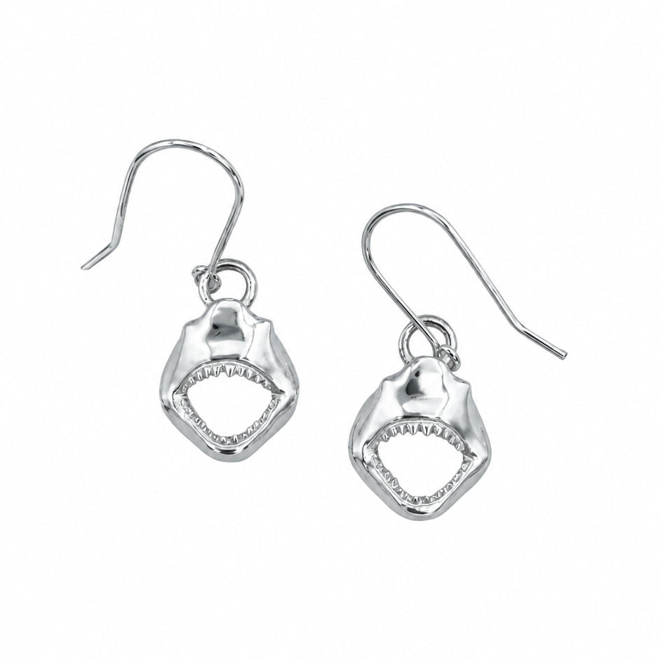 A pair of silver drop earrings featuring textured shark mouth charms with open jaws, shown on a plain white background.