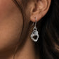 A pair of silver dangling earrings shaped like stylized shark mouth on lady model