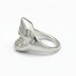 Silver ring with a shark tooth design on a gray background