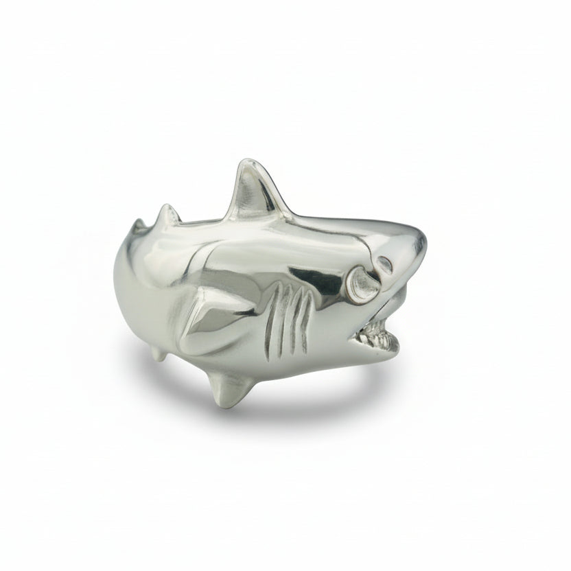 Silver shark-shaped object on a white background