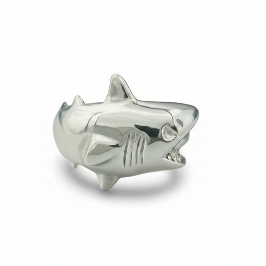 Silver shark-shaped object on a white background