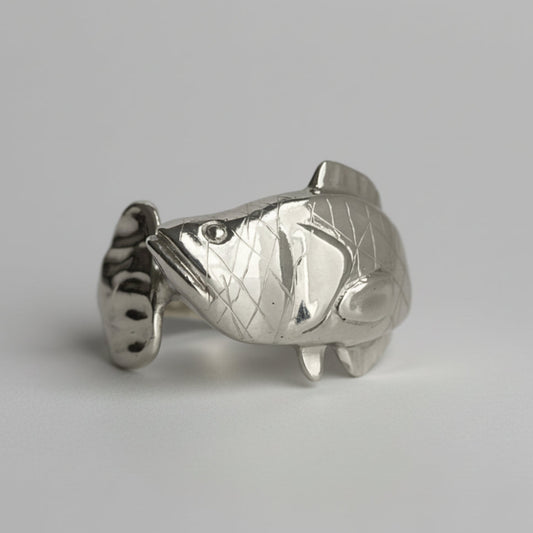 Silver Snakehead fish-shaped object on a light gray background