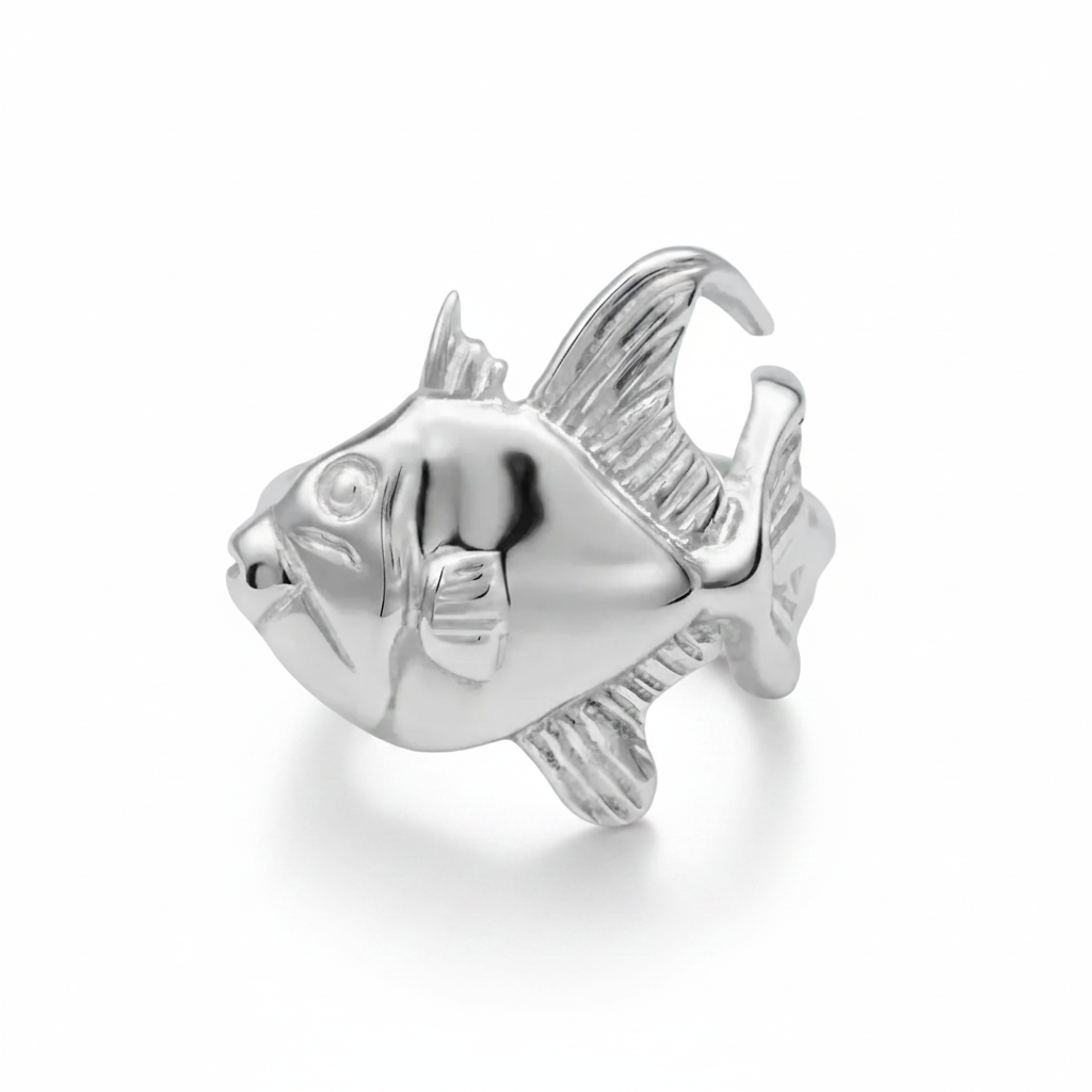 A polished silver ring sculpted in the shape of a fish, shown on a clean white background.
