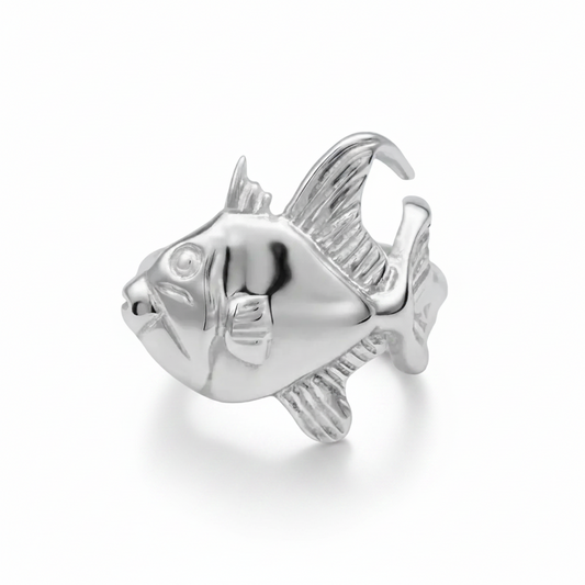 A polished silver ring sculpted in the shape of a fish, shown on a clean white background.